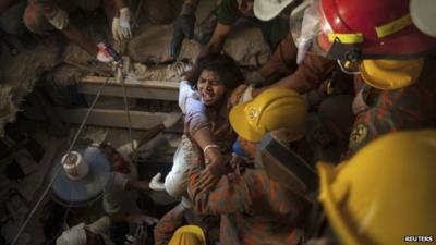 Rescue workers release a garment worker from the rubble of the collapsed Rana Plaza building