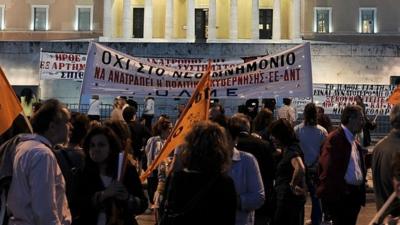 Demonstrators protest in front of parliament in Athens