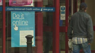 Universal Credit poster in window