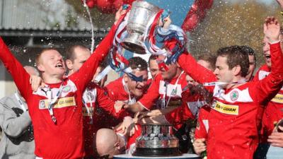 George McMullan and Chris Scannell lift the Gibson Cup