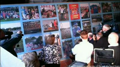 People looking at the jigsaw before it fell over.