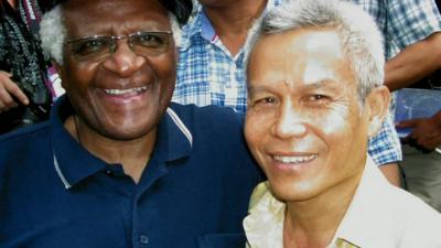 Archbishop Desmond Tutu (L) and Laos activist Sombath Somphone (R)