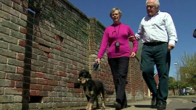 Husband walks with his wife who has dementia
