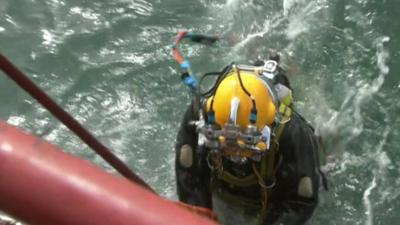 Diver working on the salvage of German World War II Dornier 17 bomber