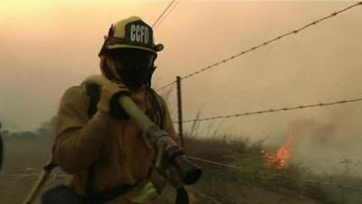 Firefighter with hose over shoulder