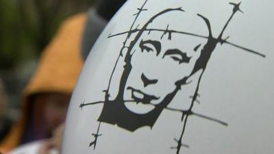 Balloon showing image of Vladimir Putin behind barbed wire