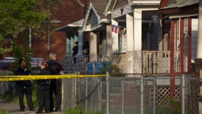 Cleveland Police stand outside a home where they say missing women, Amanda Berry, Gina DeJesus and Michele Knight were found