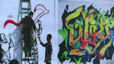 Graffiti being sprayed on a wall as part of the workshop