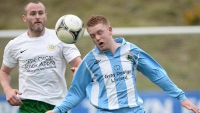 Donegal Celtic's Conor Downey battles with Warrenpoint Town's Kenny Kearns in the Irish Premiership promotion/relegation play-off first leg