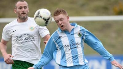 Donegal Celtic's Conor Downey battles with Warrenpoint Town's Kenny Kearns in the Irish Premiership promotion/relegation play-off first leg