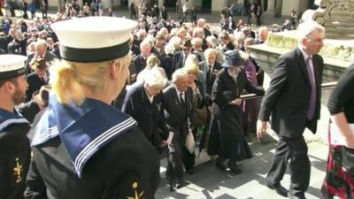 Veterans arrive at a commemorative event