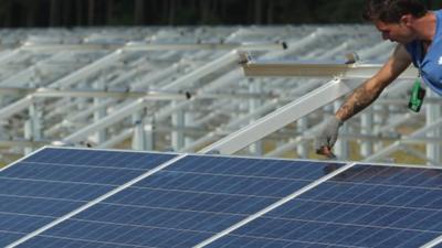 Man measuring solar panels