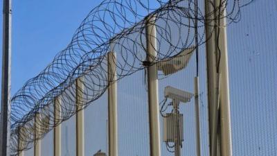 Razor wire on top of the fence at Wormwood Scrubs