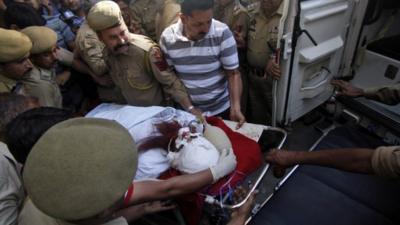 Pakistani prisoner Sanaullah Ranjay is carried on a stretcher