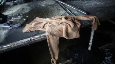 Clothes, produced in a factory belonging to Tung Hai Group, a large garment exporter, are seen after a fire in Dhaka