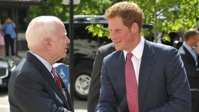 Senator John McCain (left) greets Prince Harry