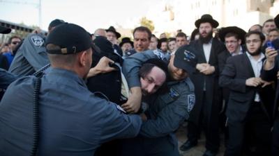 Israeli police officers arrest an ultra-Orthodox protestor objecting to the religious group "Women Of The Wall"