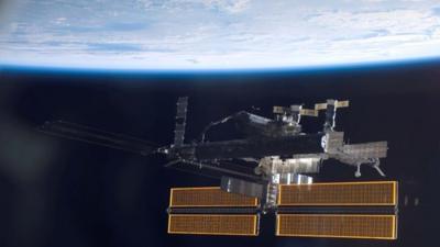 The International Space Station over a blue and white Earth