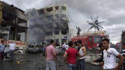 People gather at the site of an explosion in the town of Reyhanli near the Turkish-Syrian border