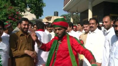 Men dancing in the street in Peshawar