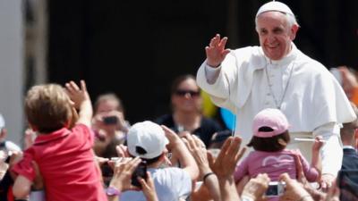 Pope Francis waves at child