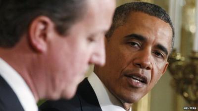 U.S. President Barack Obama (R) looks toward Britain"s Prime Minister David Cameron (L) during a joint news conference in the East Room of the White House in Washington