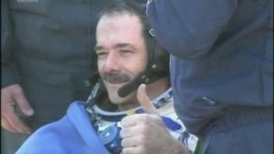 Commander Hadfield giving thumbs-up