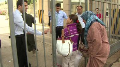 Woman and child stopped at border gate