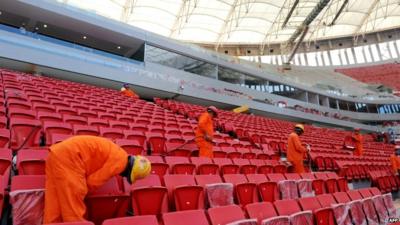 Workers place the seats in the National Stadium of Brasilia