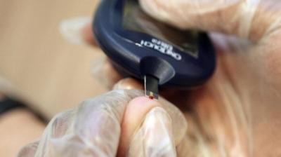 Patient with diabetes undergoing blood testing for glucose levels