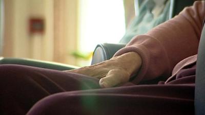 An elderly person's hand