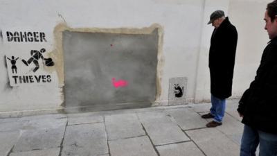 A section of wall where a Banksy mural was removed from