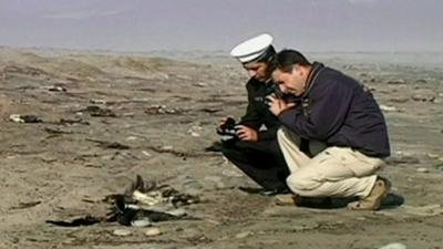 Police officials take photos of dead birds