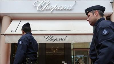 Anti-riot police officers patrol outside a Chopard shop in Cannes