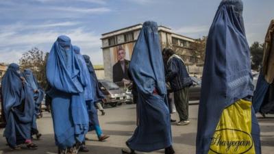 Afghan women walk through the street in Kabul