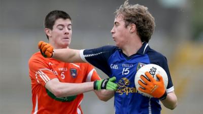 Jamie Cosgrove of Armagh tries to win the ball off Cavan's David Brady