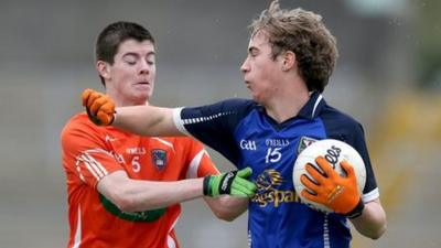 Jamie Cosgrove of Armagh tries to win the ball off Cavan's David Brady