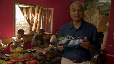 George Alagiah in shoe factory