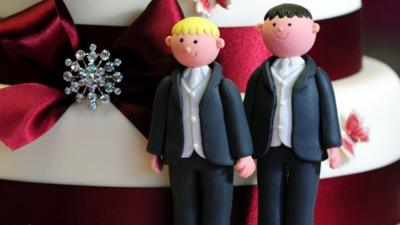 Two grooms on a wedding cake