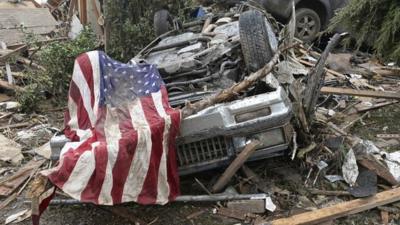 Overturned car and American flag