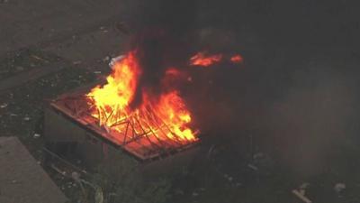 This photo provided by KFOR-TV shows a house fire outside Moore, Okla