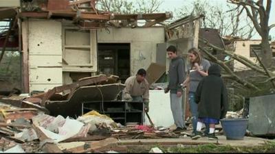 People searching through a damaged building