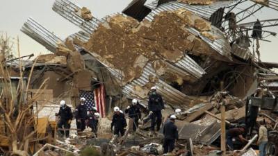 Rescue workers comb through debris at Plaza Towers Elementary School in Moore