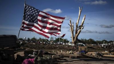 An American flag flies by the devastated town of Moore, Oklahoma