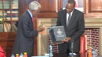 Uhuru Kenyatta receiving the report