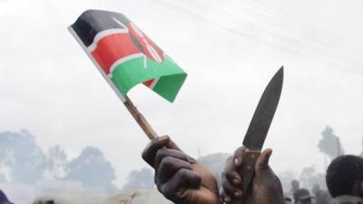 A Kenyan flag and knife held aloft after elections in 2007