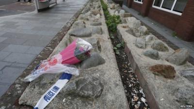 Flowers lie near a crime scene where one man was killed in Woolwich, south east London