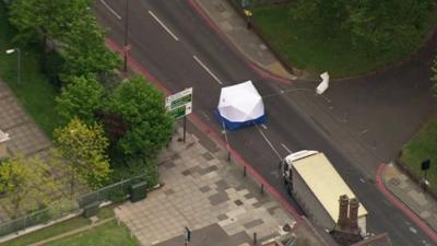 A forensic tent set up in the road