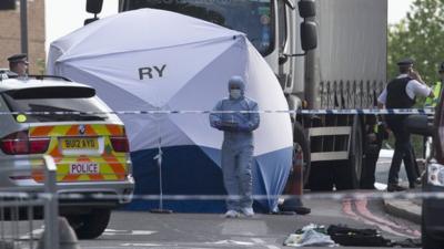 Police and forensic officers near the scene of an attack