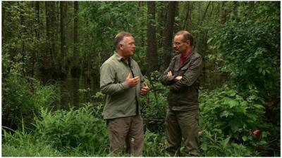 Roger Harrabin talking to an environmentalist in a forest